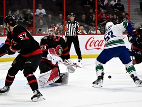 Vancouver Canucks center Bo Horvat (53) controls the puck before it hits Ottawa Senators goaltender Cam Talbot (33) during first NHL hockey action in Ottawa on Tuesday, November 8, 2022.