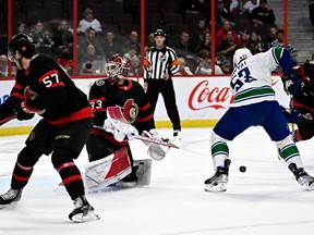 Vancouver Canucks Center's Bo Ho-Butt (53) resolves the puck before scoring over Ottawa Senators goaltender Cam Talbot (33) during first period NHL hockey action in Ottawa, Tuesday, November 8, 2022. .