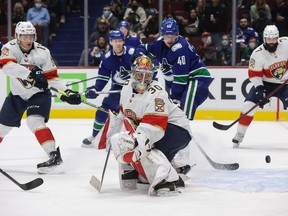 Canucks centre Elias Pettersson watches as his shot deflects off the post against Florida Panthers goalie Spencer Knight during a Jan. 21, 2022 NHL game at Rogers Arena.