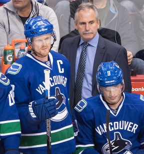 Then-Canucks coach Willie Desjardins with captain Henrik Sedin look on from the bench during a November 2016 NHL game at Rogers Arena.