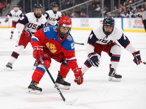 Russia's Daniil Gushchin (15) is pursued by the United States' John Farinacci (9) and Mitchell Miller (4) during second period Hlinka Gretzky Cup bronze medal game action in Edmonton on Saturday, August 11, 2018.