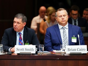 Witnesses Scott Smith, Hockey Canada president and chief operating officer (left), and Hockey Canada Chief Financial Officer Brian Cairo appear at the standing committee on Canadian Heritage in Ottawa in July.