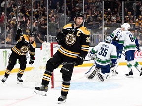 Boston Bruins centre Patrice Bergeron (37) reacts after scoring a goal on Vancouver Canucks goaltender Thatcher Demko (35) during the first period at the TD Garden.