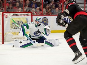 Nov 8, 2022: Vancouver Canucks goalie Spencer Martin (30) makes a save on a shot by Ottawa Senators left wing Austin Watson (16) in the first period at the Canadian Tire Centre.