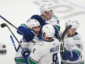 Vancouver Canucks left wing Andrei Kuzmenko (96) celebrates with centre J.T. Miller (9) and left wing Tanner Pearson (70) and defenceman Tyler Myers (57) after scoring a goal against the San Jose Sharks during overtime at SAP Center at San Jose.