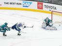 The Vancouver Canucks scored left winger Andrei Kuzmenko (96) against San Jose Sharks goalkeeper Kaapo Kakonen (36) and defenseman Matt Benning (5) during overtime at the SAP Center in San Jose.