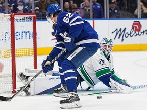 Vancouver Canucks goaltender Spencer Martin (30) makes a save on Toronto Maple Leafs forward Denis Malgin (62) during the first period at Scotiabank Arena Nov. 12, 2022.