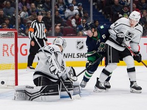 Los Angeles Kings defenceman Mikey Anderson (44) looks on as Vancouver Canucks forward Brock Boeser (6) scores on goalie Jonathan Quick (32) in the second period at Rogers Arena on Friday.