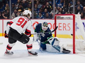 New Jersey Devils forward Dawson Mercer (91) scores on Vancouver Canucks goalie Thatcher Demko (35) in the second period at Rogers Arena.