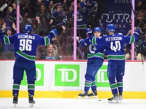 Vancouver Canucks forward Ilya Mikheyev celebrates his goal against the Nashville Predators alongside forward Elias Petersson and forward Andrei Kuzmenko in the first period at Rogers Arena.