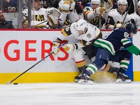 Vancouver Canucks defenseman Riley Stillman (61) checks on Vegas Golden Knights forward Keegan Kollcer (55) in the second period at Rogers Arena.