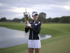 Nelly Korda holds the championship trophy after winning the LPGA Pelican Women's Championship golf tournament at Pelican Golf Club, Sunday, Nov. 13, 2022, in Belleair, Fla.