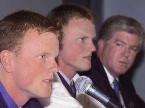 Then-Canucks general manager Brian Burke (right) looks on at his handiwork as highly touted Swedish twin teen draftees Daniel and Henrik Sedin are introduced to the Vancouver media after signing their first professional contracts with the club in July 1999. The pair went to forge Hockey Hall of Fame-worthy careers over 17 seasons with the same club.