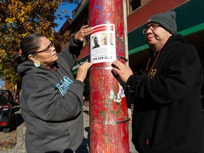 Jamie and Rex Smallboy, the aunt and father of missing man Darius Smallboy, put up posters seeking information on the young man's whereabouts. He was last seen on Nov. 3 on the Downtown Eastside.