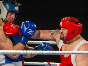 Boxers Jacob Illichmann (in red) and Kai Sommers (in blue) during Night of Fights boxing gala at Vancouver's Italian Cultural Centre on Nov. 17, 2022.