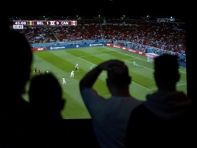 Anxious moments for Canada soccer fans at the Hollywood Theatre as they watch replays of the game’s only goal that led to Belgium’s 1-0 win.