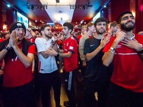 Fans at the Hollywood Theatre in Kitsilano cheer on Team Canada as they took on Belgium in their opening game at the 2022 World Cup in Qatar.