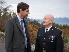 B.C. Premier David Eby, left, and Vancouver Police Chief Adam Palmer talk after Eby announced a new public safety plan in Vancouver, on Sunday, Nov. 20, 2022.