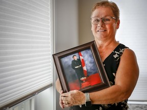 National Silver Cross Mother Candace Greff poses with a picture of her son MCpl. Byron Greff, who was the last soldier to die in Afghanistan, at her home in Lacombe, Alta., Tuesday, Oct. 25.