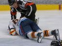 Vancouver Canucks prospect Jonathan Lekkerimaki is tended to by a referee after taking a hard hit to the head on Saturday.