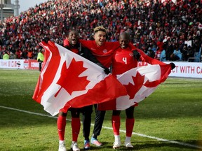 Canadian players celebrate in March after qualifying to the 2022 World Cup.