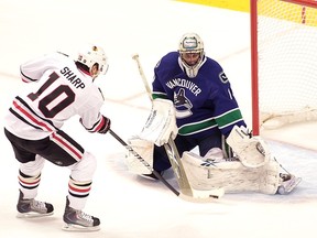 Vancouver Canucks’ goalie Roberto Luongo makes the save against Chicago Blackhawks’ Patrick Sharp during the first period in game 6 of the NHL Western Conference semifinal hockey game in Vancouver on May 11, 2010.