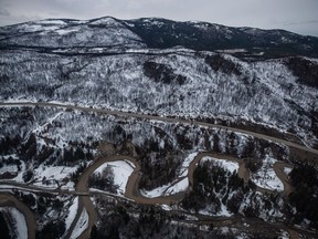 A mountainside is covered with snow as the Coldwater River snakes along side the Coquihalla Highway south of Merritt, B.C., on Nov. 22, 2021. Environment Canada has issued more than a dozen snowfall warnings and winter storm watches for communities in southern British Columbia.