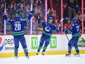 Elias Pettersson, celebrating a recent goal with Curtis Lazar and Quinn Hughes (right), is ‘a gamer for a guy who’s not that big in stature,’ says Lazar, who adds that he didn’t realize how complete a player the slick Swede was until he joined the Canucks this season.