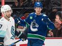 Elias Pettersson of the Vancouver Canucks celebrates after scoring a goal as Jordan Eberle of the Seattle Kraken looks on during the second period in NHL action on December, 22, 2022 at Rogers Arena.