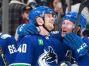 Canucks centre Elias Pettersson, left, and Brock Boeser celebrate after Thursday's 6-5 shootout win over the Seattle Kraken in which Pettersson posted a five-point night and the shootout decider, his first game back in the lineup after being sidelined for a week by illness.