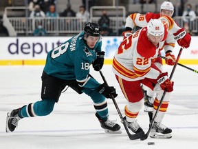 Lane Pederson of the San Jose Sharks and Trevor Lewis of the Calgary Flames Dec. 7, 2021 in San Jose, California.