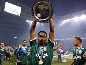 Palmeiras' Endrick celebrates with the trophy after winning the Brasileiro Championship.