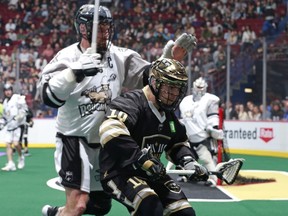 Calgary's Jesse King and Vancouver's Logan Schuss fight for a loose ball during Friday's NLL game between the Calgary Roughnecks and Vancouver Warriors at Rogers Arena. The Warriors lost 14-5.
