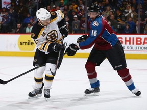 Cory Sarich of the Colorado Avalanche defends against Jarome Iginla of the Boston Bruins at Pepsi Center on March 21, 2014 in Denver, Colorado.