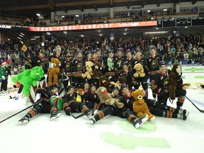 The Vancouver Giants show off some of their Teddy Bear bounty following Dylan Anderson's goal on Saturday night in the annual holiday game.