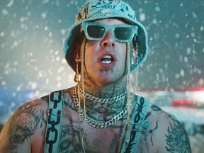 In this still photo, Canadian rapper Tom MacDonald is seen in his music video for the song Snowflakes. After it was released on YouTube in June 2021, he gained more recognition, including a Twitter follow from Donald Trump Jr. and an interview in The Daily Wire with Ben Shapiro, a conservative political commentator.