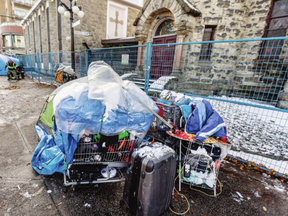 Snow covers tents and belongings on the sidewalk of 900 block of Pandora Avenue. People who are homeless are being affected by the outbreak, Island Health says.