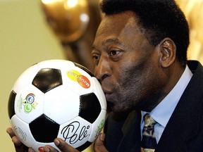 In this file photo taken on Dec. 8, 2005, Brazilian football legend Pele kisses a ball, during a presentation in Leipzig on the eve of the final draw of the Fifa football World Cup 2006.