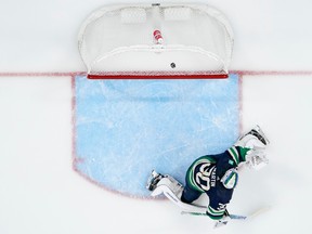 Vancouver Canucks goaltender Spencer Martin is unable to stop a goal by San Jose Sharks centre Nick Bonino 18 seconds into the first period on Wednesday.
