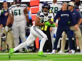 Seattle Seahawks wide receiver Tyler Lockett (16) runs the ball against the Los Angeles Rams during the second half at SoFi Stadium.