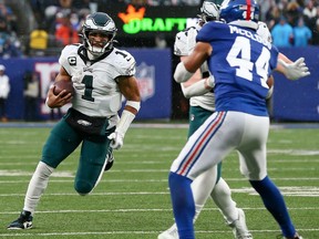 Philadelphia Eagles quarterback Jalen Hurts (1) carries the ball against the New York Giants during the fourth quarter at MetLife Stadium.