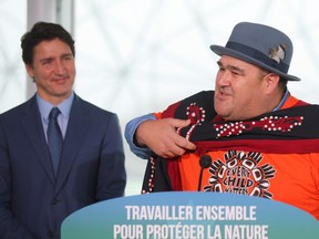 Prime Minister Justin Trudeau looks on as Dallas Smith, president Nanwakolas Council (B.C.) speaks during an announcement supporting Indigenous-led conservation at the COP15 U.N. biodiversity conference in Montreal on Wednesday.