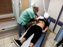 A patient suffering from Long COVID is examined in the post-coronavirus disease (COVID-19) clinic of Ichilov Hospital in Tel Aviv, Israel, Feb. 21, 2022.