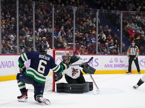 Vancouver Canucks' Brock Boeser (6) scores against Arizona Coyotes goalie Karel Vejmelka, of the Czech Republic, during the third period of an NHL hockey game in Vancouver, on Saturday, December 3, 2022.
