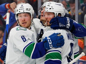 The Vancouver Canucks celebrate a goal by forward J.T. Miller (9), his second of the game during the second period against the Edmonton Oilers at Rogers Place.