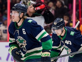 Brock Boeser, heading to bench after scoring Saturday against Arizona, and Elias Pettersson (right) were aligned again Monday at Rogers Arena.