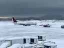 Scenes from YVR on Dec. 20, 2022, after an overnight winter storm blanketed the region with snow. 