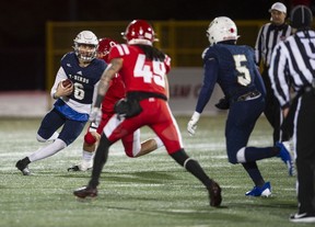 UBC Thunderbirds QB Derek Engel runs the ball downfield while trying to avoid being tackled by players of the crosstown rivals the Simon Fraser University Red Leafs during the 34th Shrum Bowl at SFU Friday, Dec. 2, 2022.