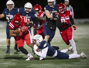 Simon Fraser University Red Leafs running back Mason Glover is tackled by Zach Herzog of the crosstown rivals the UBC Thunderbirds, during the 34th Shrum Bowl at SFU Friday, Dec, 2, 2022.