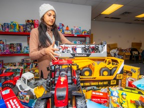 A volunteer stocks a table with toys at the Junction Shopping Centre in Mission.
